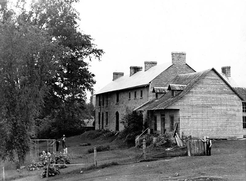 Black-and-white photo of Horaceville, showing original log wing, 1941