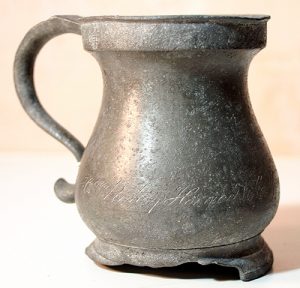A colour photo of a pewter mug, engraved "H.K. Pinhey, Horaceville, Upper Canada", ca. 1820-1840. We know from his diaries that Hamnett Pinhey grew hops to brew beer. (PPF Collections)