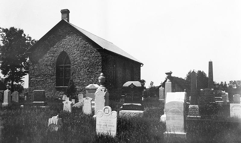 A black-and-white photo of St John's Anglican Church and Cemetery, South March, 1925 (LAC PA26809). The church marked its 175th anniversary in 2014.