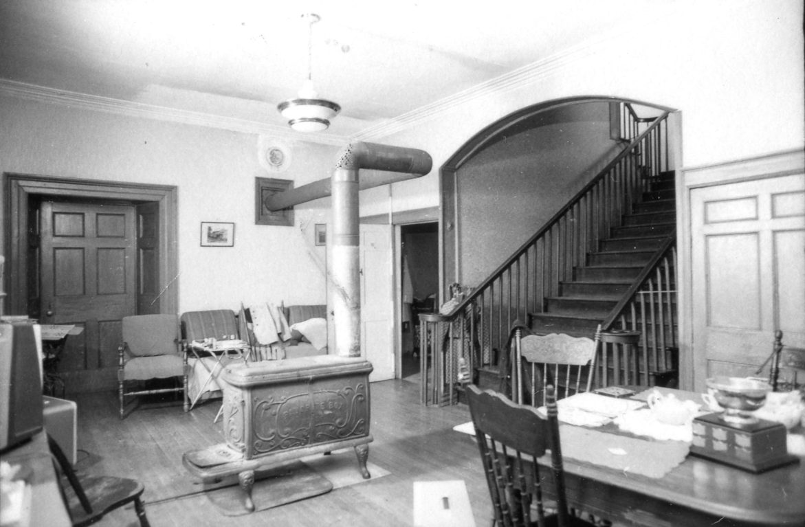 A 1975 photo shows a box stove in the front hall, made by Findlay Stoves, Carleton Place. (PPF photo collection, Gift of Gerald White 2012)